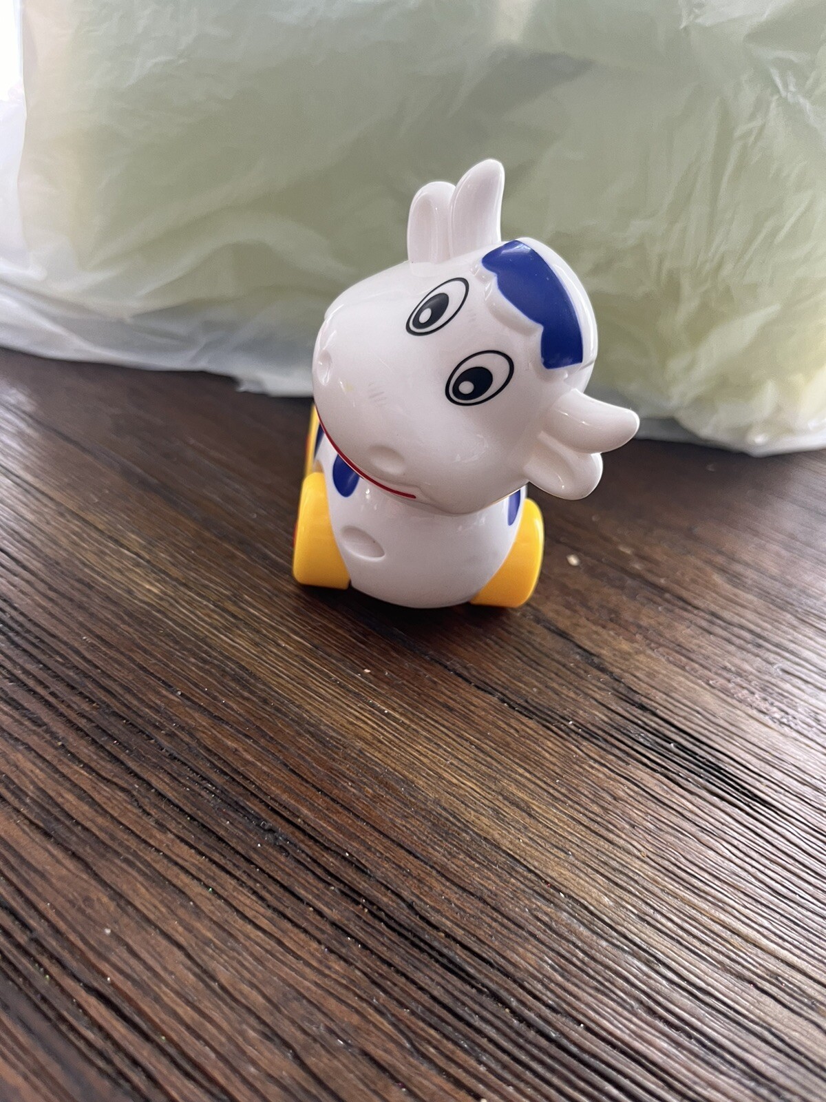 Small Cow on wheels toy with turning head