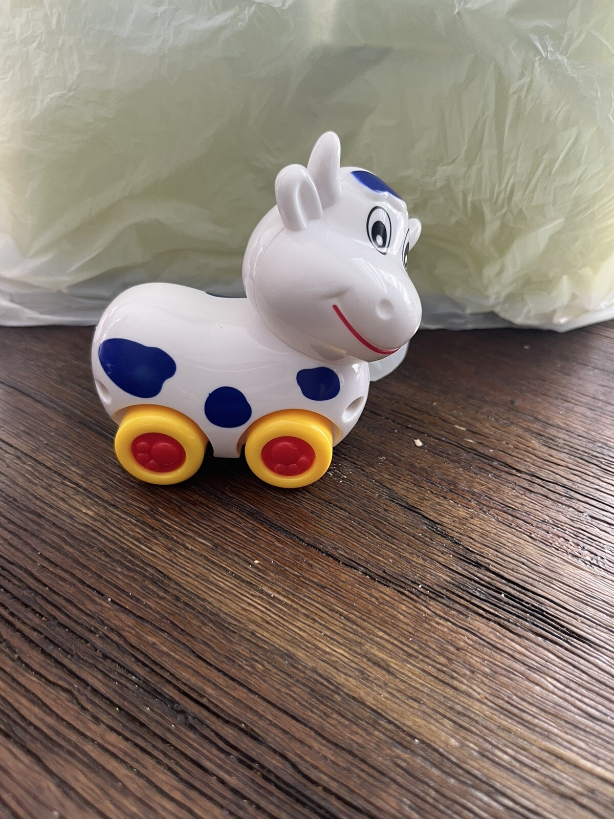 Small Cow on wheels toy with turning head
