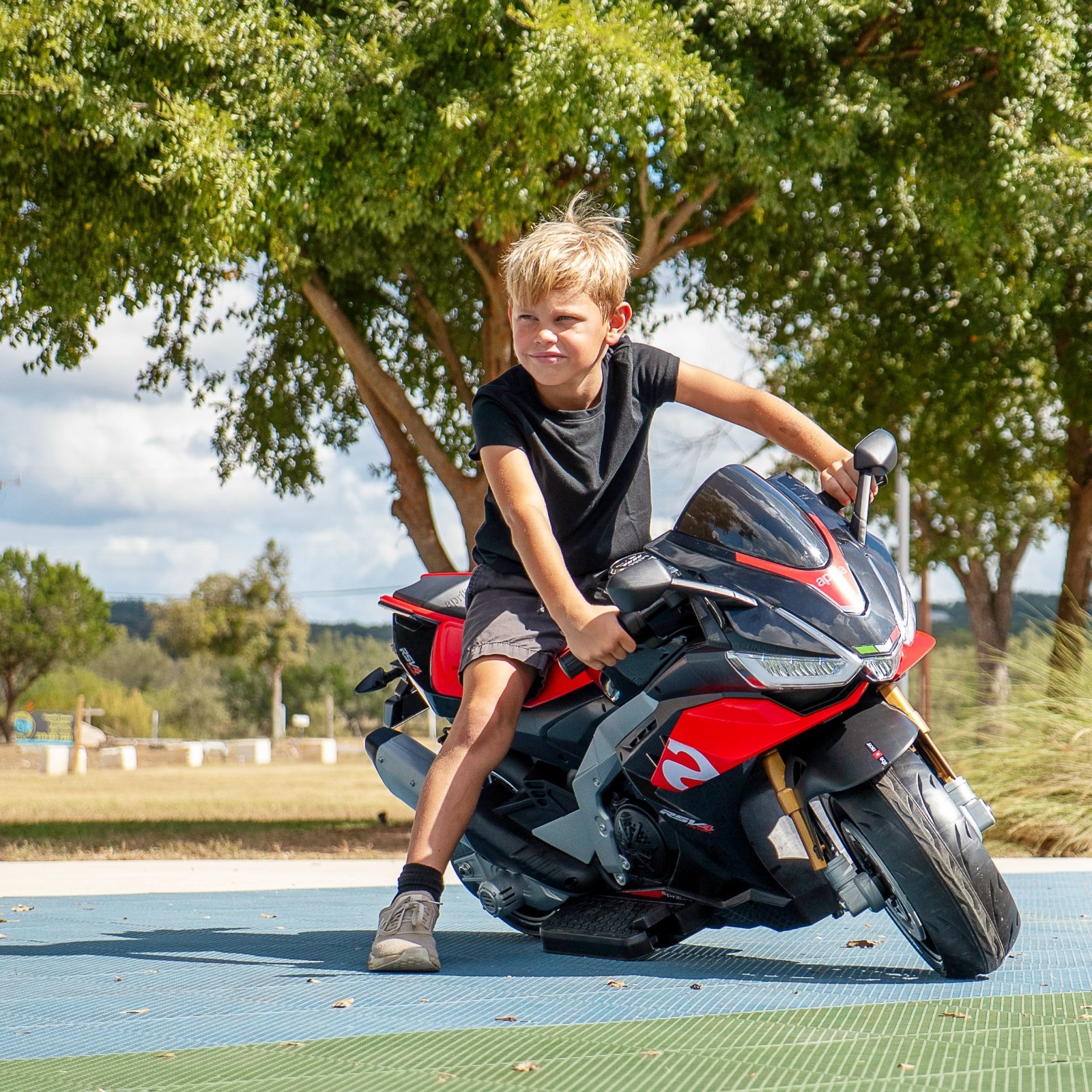 Aprilia 24V Kids Electric Motorcycle 6mph Dirt Bike Ride on Toy w/ Bluetooth MP3