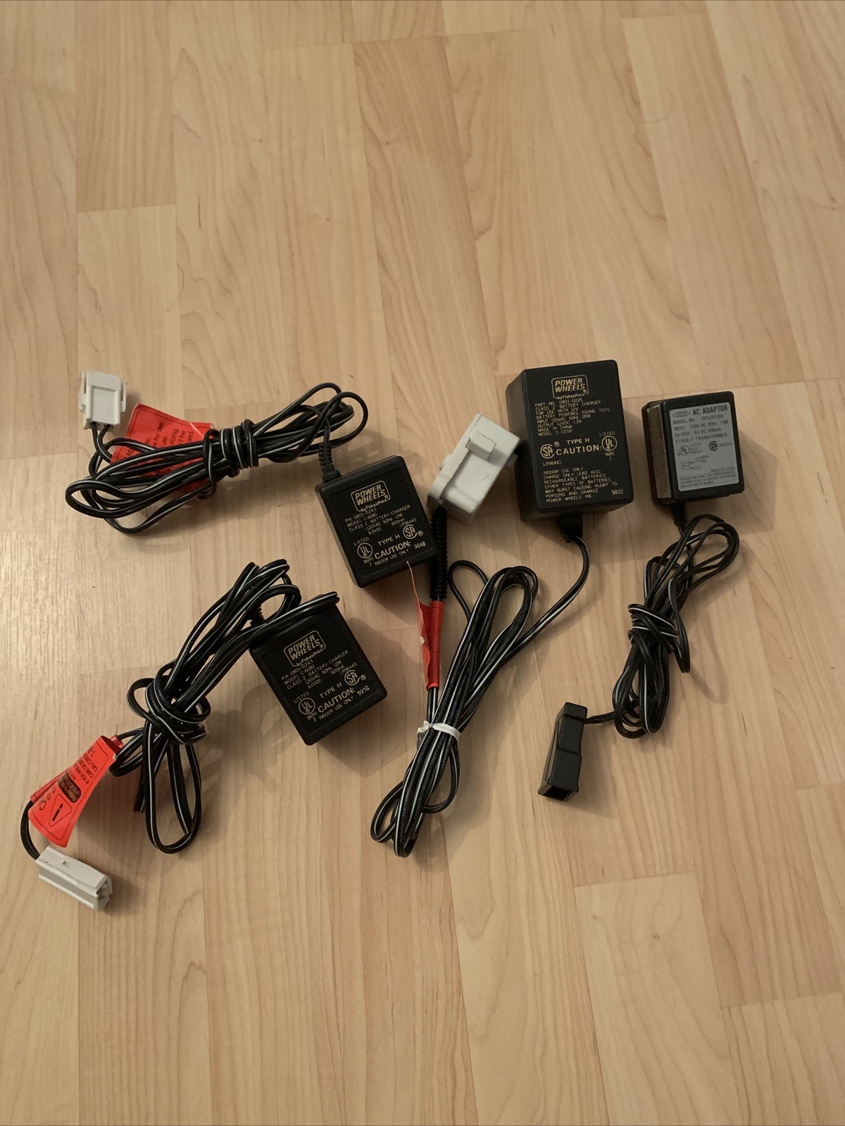 Set of four type H power wheels by Fisher-Price battery chargers