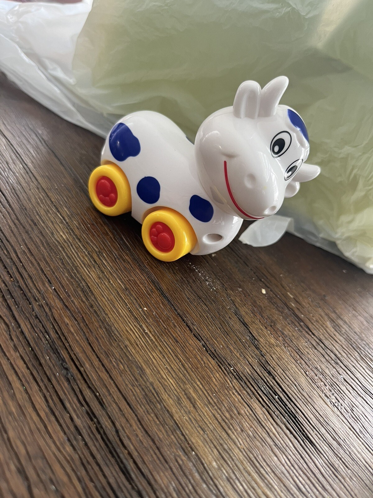 Small Cow on wheels toy with turning head