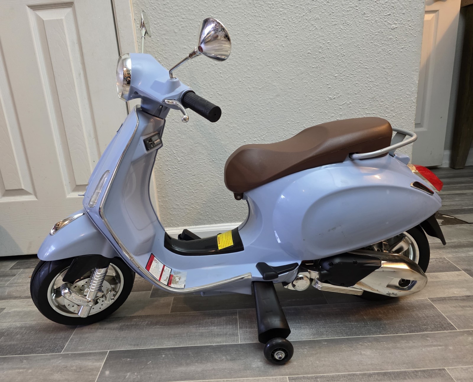 Blazin’ Wheels 12V Vespa GTS Super Sport battery-operated ride-on scooter. Kids